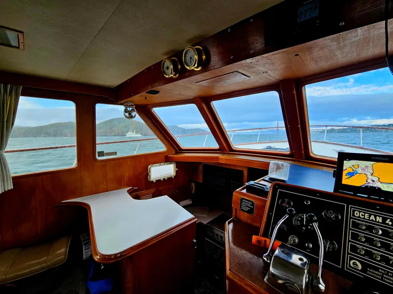 Slide: The Image of Interior view of 1983 Ocean Alexander 43 yacht cockpit with navigation equipment and scenic ocean view. - 20