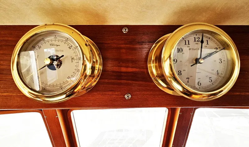 Slide: The Image of Brass barometer and clock on 1983 Ocean Alexander 43 yacht dashboard. - 30