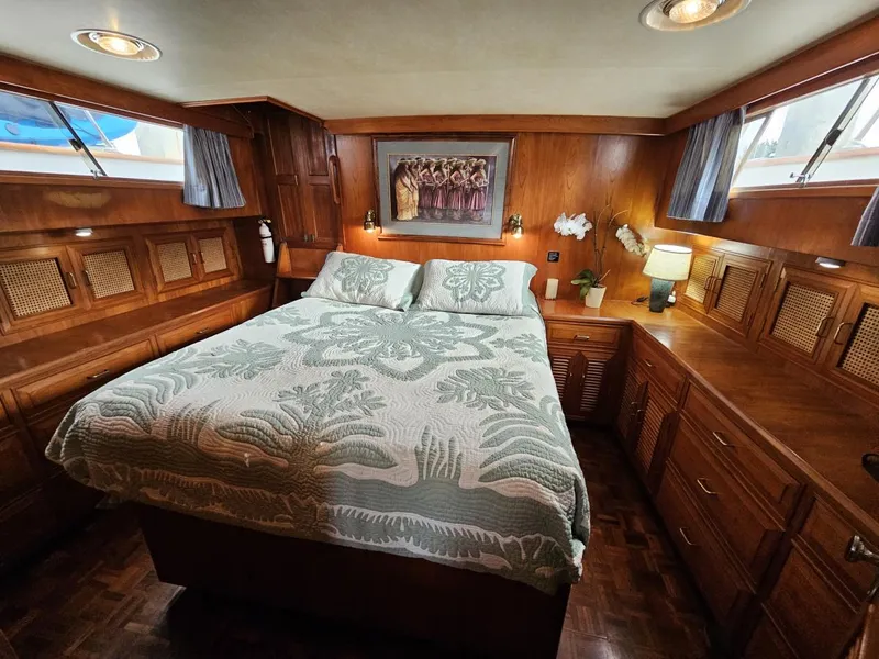 Slide: The Image of Luxurious 1983 Ocean Alexander 43 yacht bedroom with wood paneling and elegant bedding. - 33