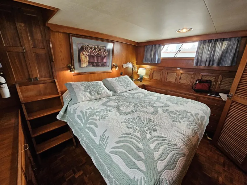 Slide: The Image of Luxurious 1983 Ocean Alexander 43 yacht bedroom with elegant wood paneling and cozy bedding. - 35