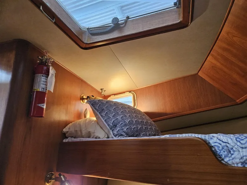 Slide: The Image of Cozy cabin interior of 1983 Ocean Alexander 43 yacht with wooden bunk and porthole. - 39