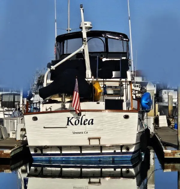 Slide: The Image of 1983 Ocean Alexander 43 yacht docked, named "Kōlea," with American flag, Ventura, CA. - 4