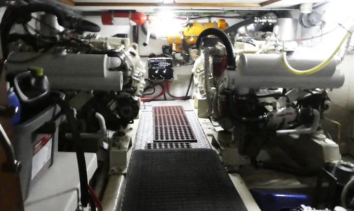 Slide: The Image of Engine room of 1983 Ocean Alexander 43 yacht, featuring dual engines and mechanical components. - 43