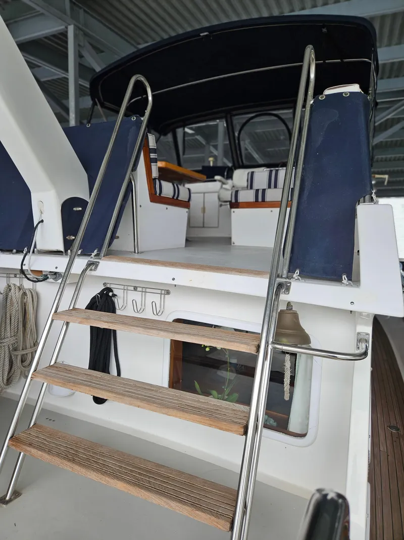 Slide: The Image of 1983 Ocean Alexander 43 yacht with ladder and covered seating area. - 5