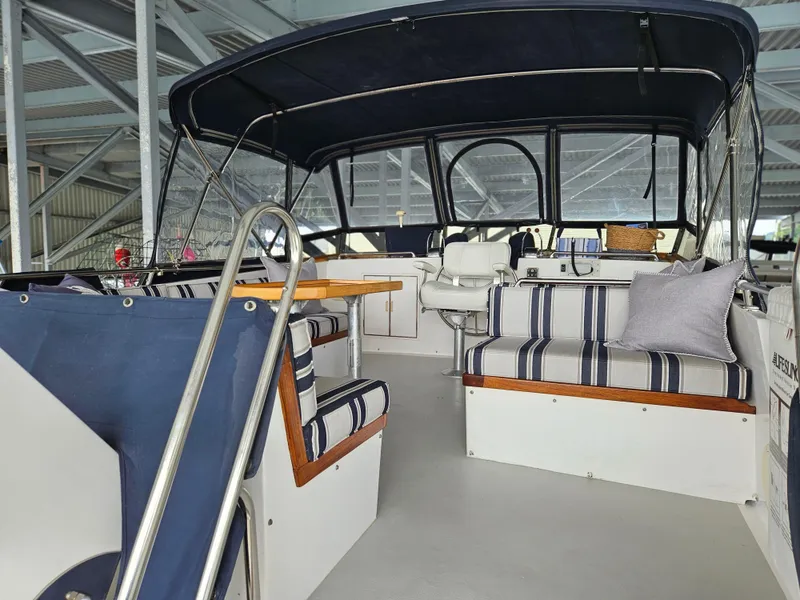 Slide: The Image of 1983 Ocean Alexander 43 yacht interior with striped seating and canopy. - 6