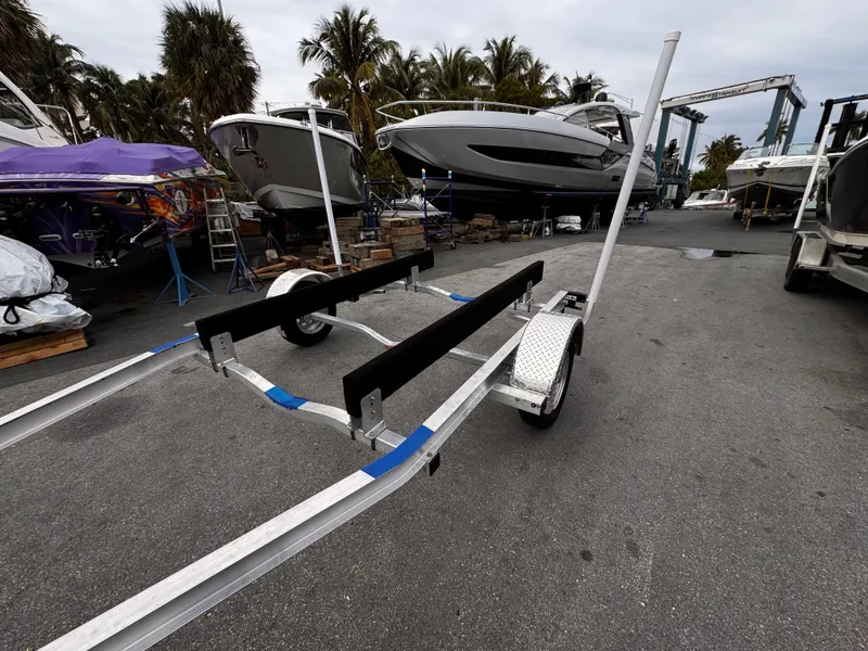 Slide: The Image of 2025 Single Axle Trailer for 17-19 ft boats in a marina setting. - 12