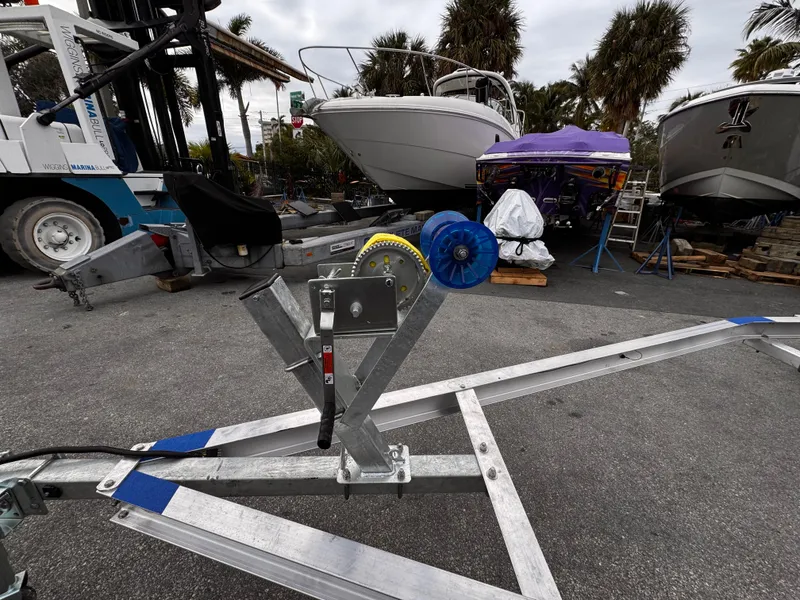 Slide: The Image of 2025 Single Axle Trailer with boats in a marina setting. - 15