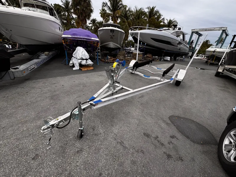 Slide: The Image of 2025 Single Axle Trailer for 17-19 ft boats, parked near marina. - 17