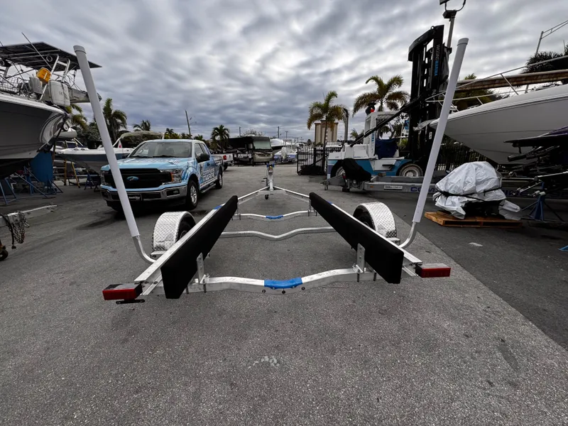 Slide: The Image of 2025 Single Axle Trailer in marina, cloudy sky, palm trees in background. - 7