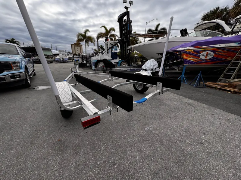 Slide: The Image of 2025 Single Axle Trailer for boats, parked outdoors near palm trees and vehicles. - 8