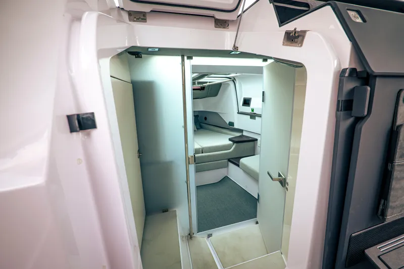 Slide: The Image of Interior of 2023 Axopar Michael Vrbas boat, featuring modern cabin design and seating area. - 15