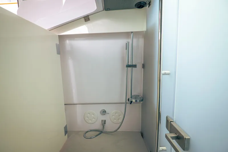Slide: The Image of Modern shower area in 2023 Axopar Michael Vrbas boat, featuring sleek design and fixtures. - 22