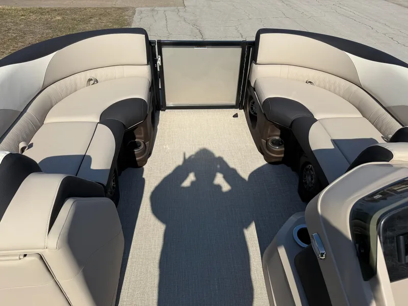 Slide: The Image of 2025 Tahoe Pontoon LTZ Quad Lounger interior with beige seating and spacious layout. - 10