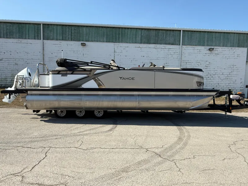 Slide: The Image of 2025 Tahoe Pontoon LTZ Quad Lounger parked outdoors, side view. - 16