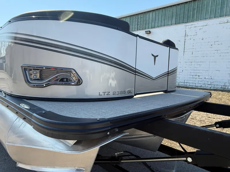 Slide: The Image of 2025 Tahoe Pontoon LTZ Quad Lounger, sleek design, parked outdoors. - 20