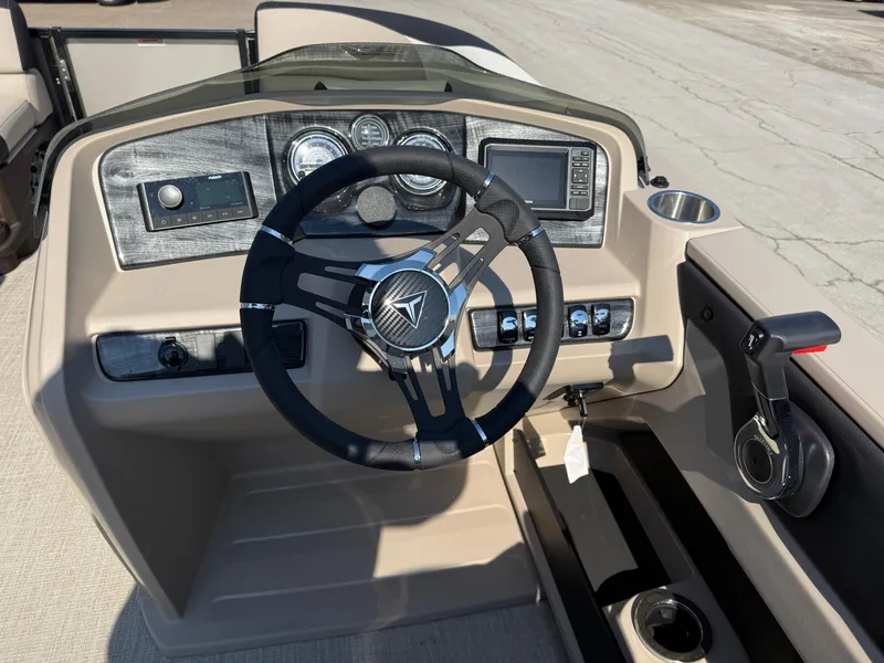 Slide: The Image of 2025 Tahoe Pontoon LTZ Quad Lounger dashboard with steering wheel and control panel. - 9