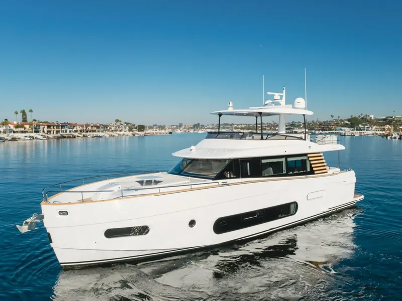 Slide: The Image of 2023 Azimut Magellano 66 yacht cruising on a sunny day in a marina. - 0