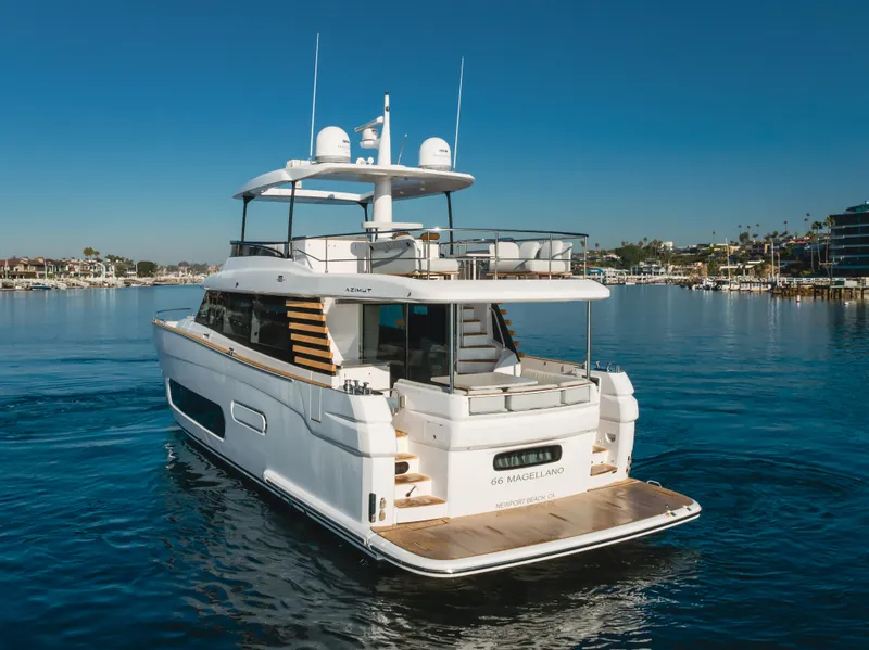 Slide: The Image of 2023 Azimut Magellano 66 yacht on calm water, rear view. - 2