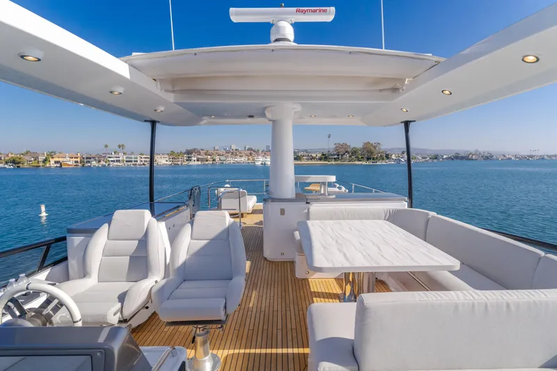 Slide: The Image of Luxurious 2023 Azimut Magellano 66 yacht deck with seating and ocean view. - 20