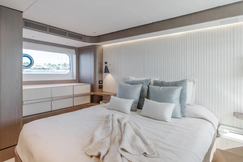 Slide: The Image of Luxurious bedroom interior of 2023 Azimut Magellano 66 yacht with modern design and cozy bedding. - 41