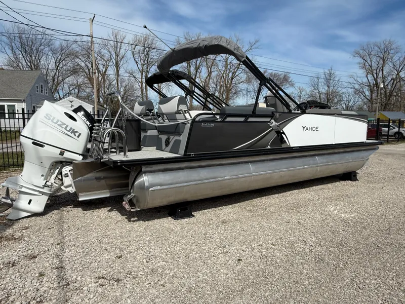 Slide: The Image of 2025 Tahoe Pontoon LTZ Quad Lounger Shift with Suzuki engine, parked outdoors. - 10