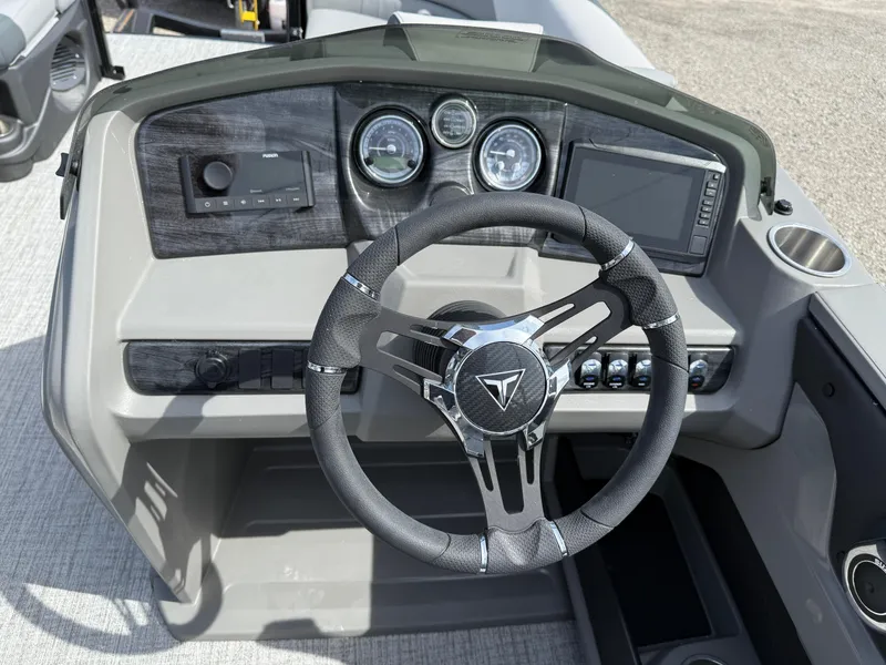 Slide: The Image of 2025 Tahoe Pontoon LTZ Quad Lounger Shift dashboard with steering wheel and controls. - 15