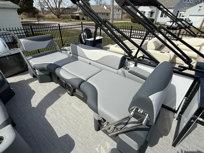 Slide: The Image of 2025 Tahoe Pontoon LTZ Quad Lounger Shift with gray seating, outdoor setting. - 16