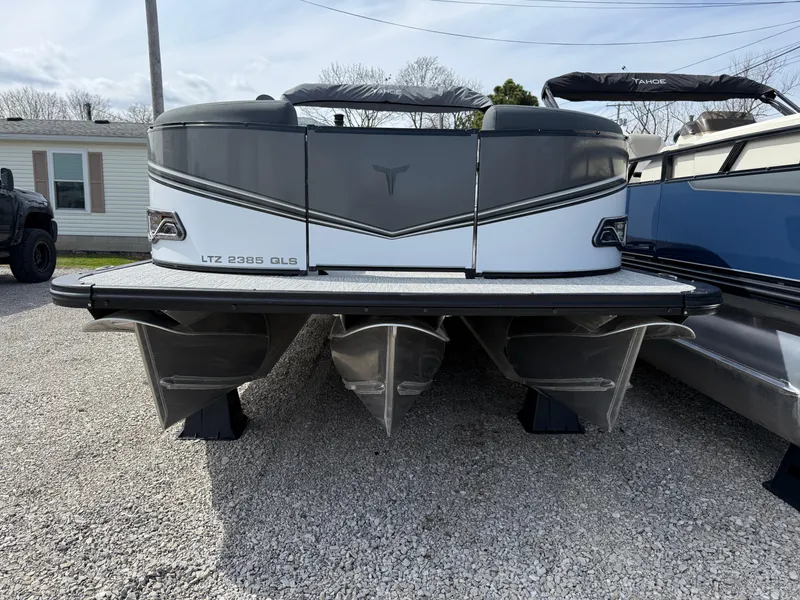 Slide: The Image of 2025 Tahoe Pontoon LTZ Quad Lounger Shift, rear view on gravel lot. - 9
