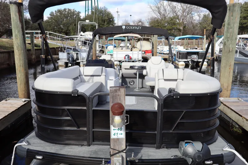 Slide: The Image of 2022 Godfrey SWEETWATER 2286 SFL pontoon boat docked at marina. - 1