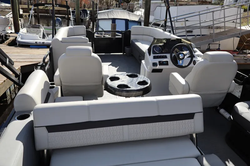 Slide: The Image of 2022 Godfrey SWEETWATER 2286 SFL pontoon boat interior with plush seating and steering console. - 14