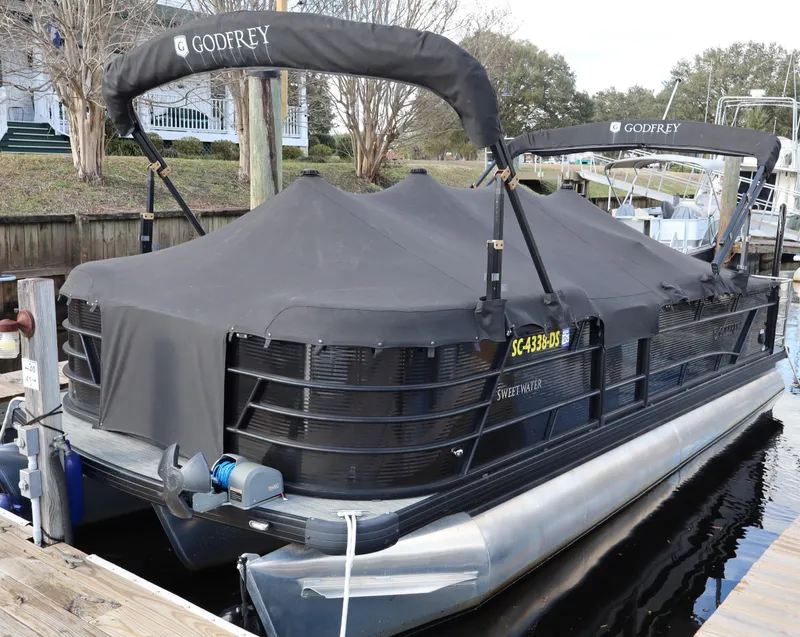Slide: The Image of 2022 Godfrey SWEETWATER 2286 SFL pontoon boat docked with cover. - 4