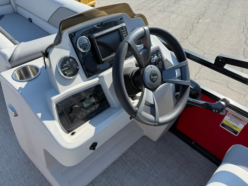 Slide: The Image of 2025 Tahoe Pontoon Sport 85 Cruise Rear Bench dashboard with steering wheel and controls. - 7