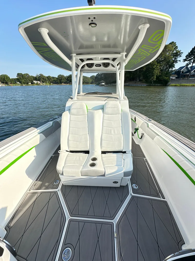 Slide: The Image of 2023 Statement 350 Open boat with sleek seating and modern design on a calm lake. - 10