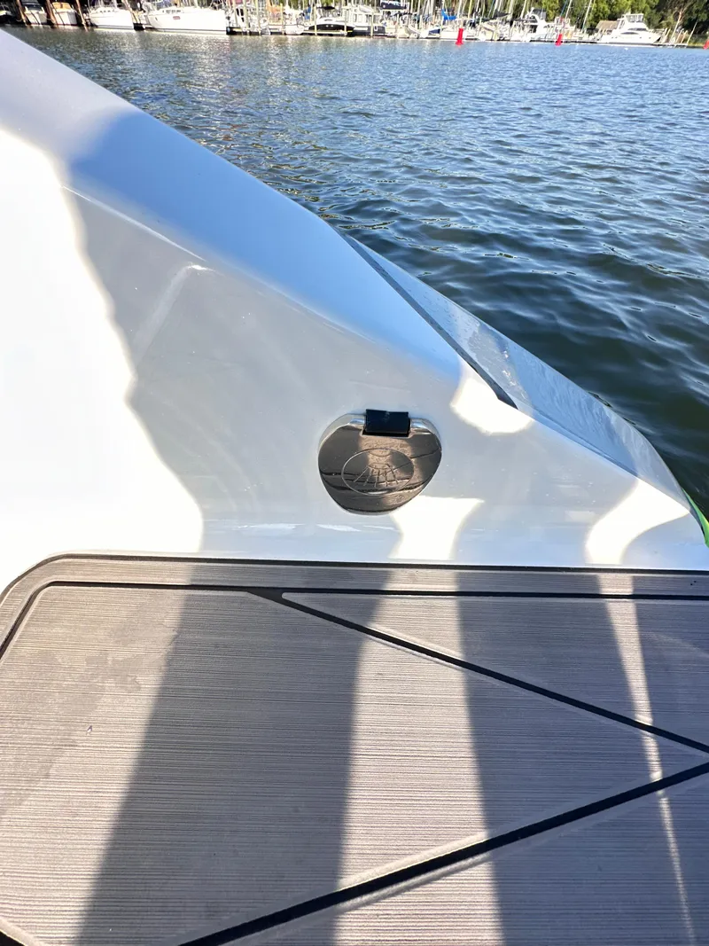 Slide: The Image of 2023 Statement 350 Open boat detail by the water, showcasing sleek design. - 21