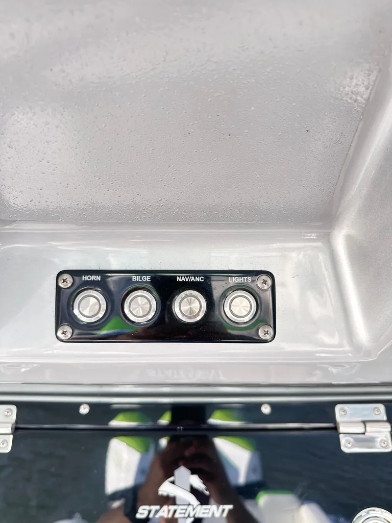 Slide: The Image of Control panel of 2023 Statement 350 Open boat with horn, bilge, nav/anc, and lights switches. - 26