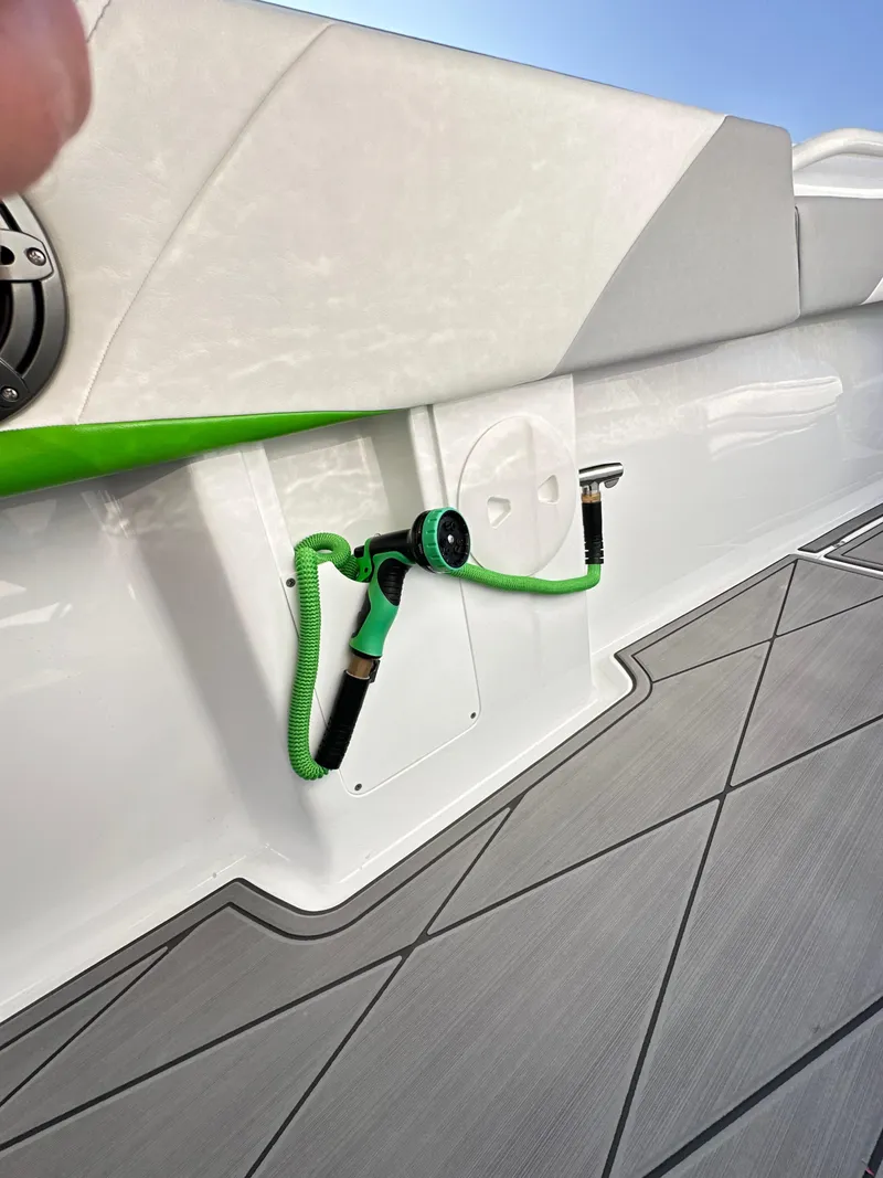 Slide: The Image of 2023 Statement 350 Open boat with green hose on deck. - 29