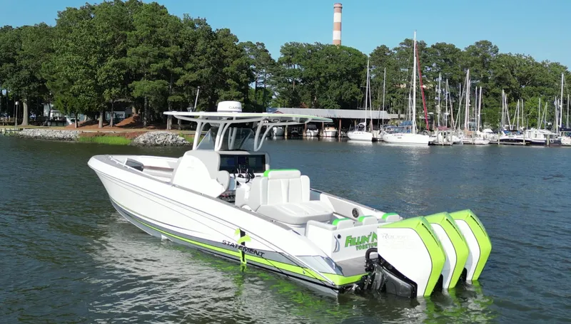 Slide: The Image of 2023 Statement 350 Open boat with triple engines on a scenic lake. - 3