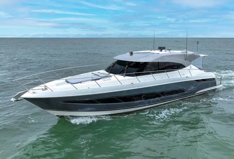 Slide: The Image of 2021 Riviera 5400 Sport Yacht cruising on open water under a clear blue sky. - 0
