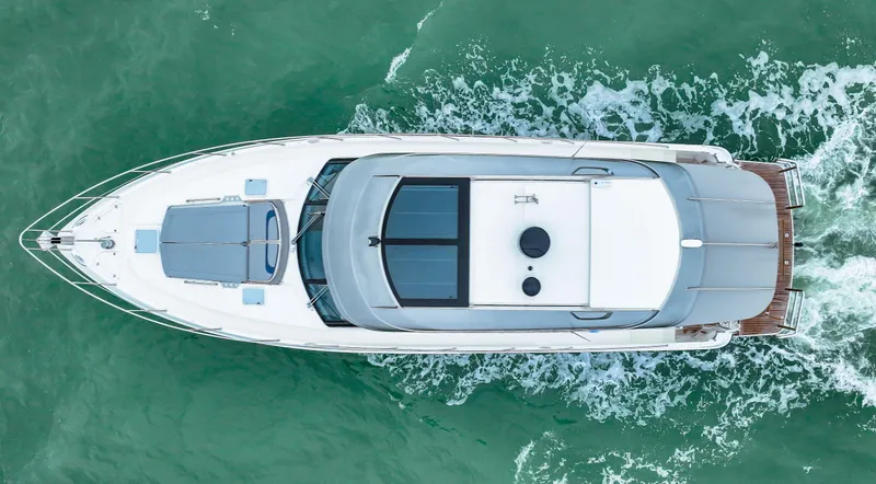 Slide: The Image of Aerial view of 2021 Riviera 5400 Sport Yacht cruising on turquoise water. - 11