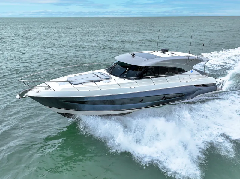 Slide: The Image of 2021 Riviera 5400 Sport Yacht cruising on open water. - 12