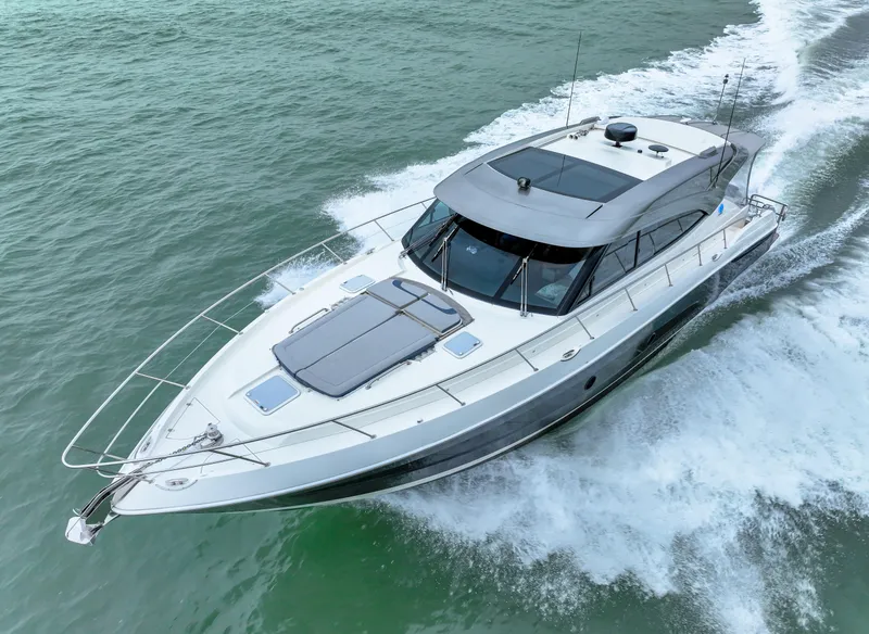 Slide: The Image of 2021 Riviera 5400 Sport Yacht cruising on open water. - 13