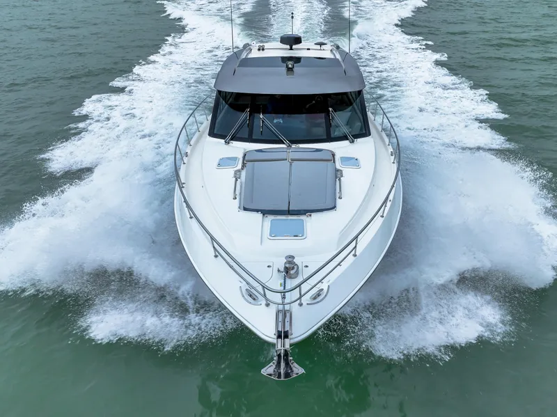 Slide: The Image of 2021 Riviera 5400 Sport Yacht cruising on open water, front view. - 14