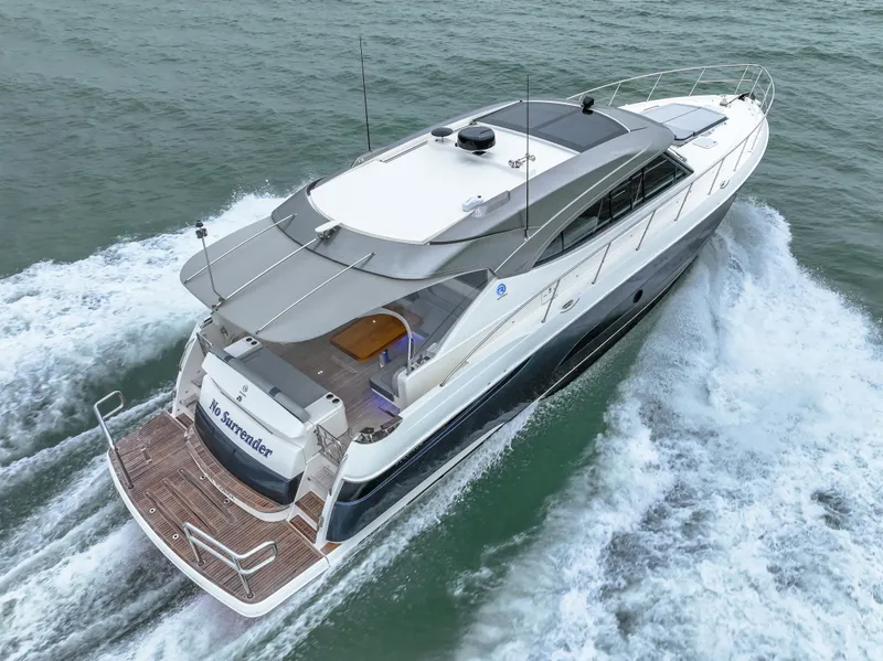 Slide: The Image of 2021 Riviera 5400 Sport Yacht cruising on open water, rear view. - 15