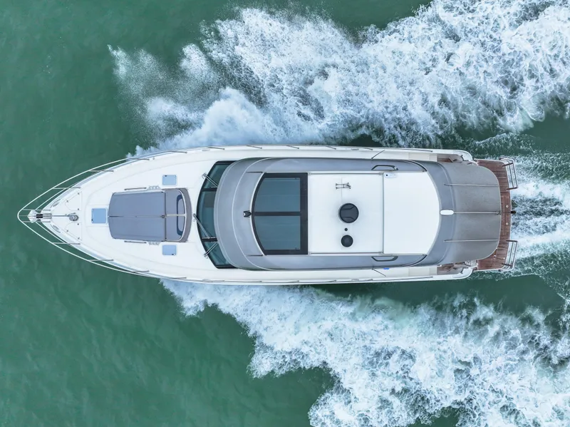 Slide: The Image of Aerial view of 2021 Riviera 5400 Sport Yacht cruising on the water. - 19
