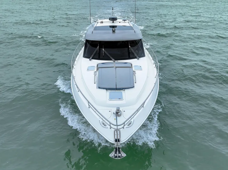 Slide: The Image of 2021 Riviera 5400 Sport Yacht cruising on open water. - 2
