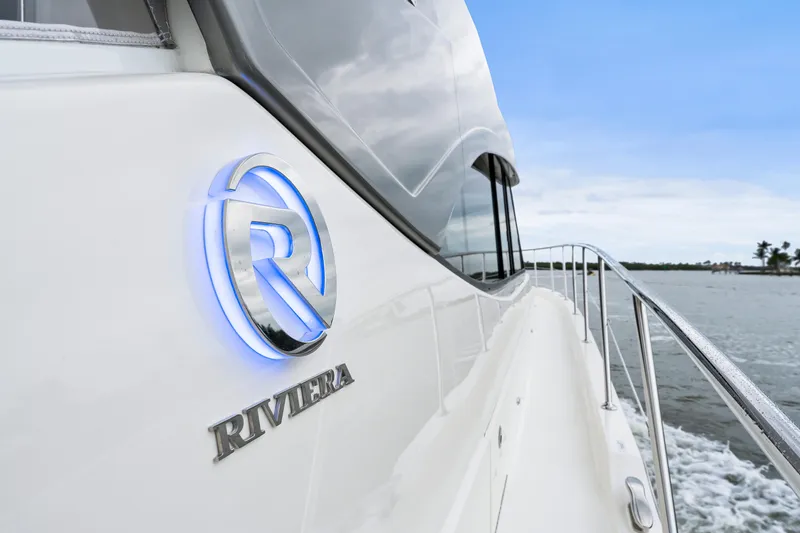 Slide: The Image of 2021 Riviera 5400 Sport Yacht cruising on open water, side view. - 28
