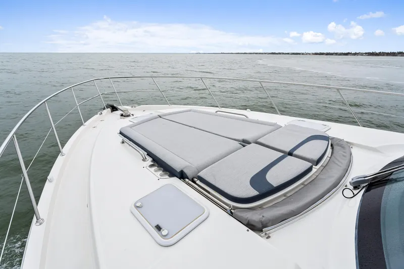 Slide: The Image of 2021 Riviera 5400 Sport Yacht deck with sun loungers on open sea. - 29