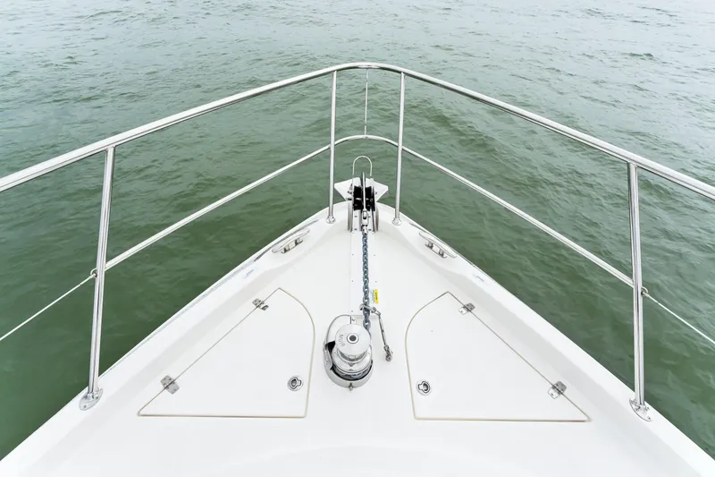 Slide: The Image of Bow of 2021 Riviera 5400 Sport Yacht on calm water. - 30