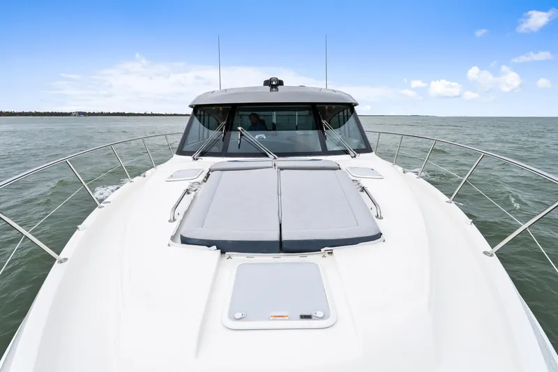 Slide: The Image of 2021 Riviera 5400 Sport Yacht on open water, showcasing sleek design and spacious deck. - 31