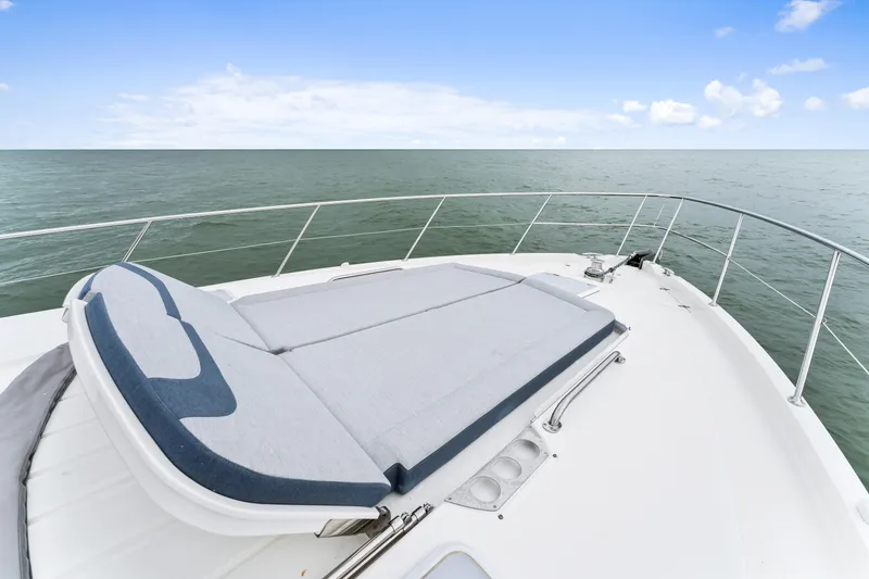 Slide: The Image of 2021 Riviera 5400 Sport Yacht deck with sunbed, ocean view. - 32